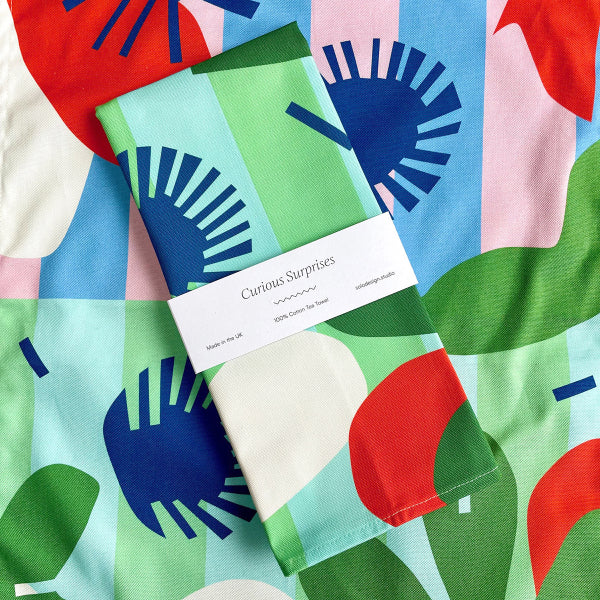 Curious Surprises Tea Towel
