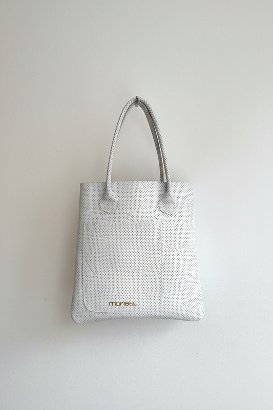 White textured tote bag with 'marisel' branding on a light gray background